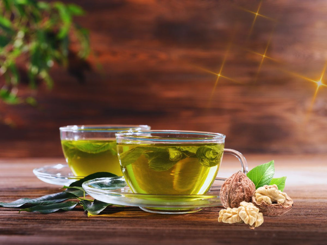 Two cups of tea wich leaves and walnuts with brown background.The Power of Green – Five Leafy Remedies for Wellbeing