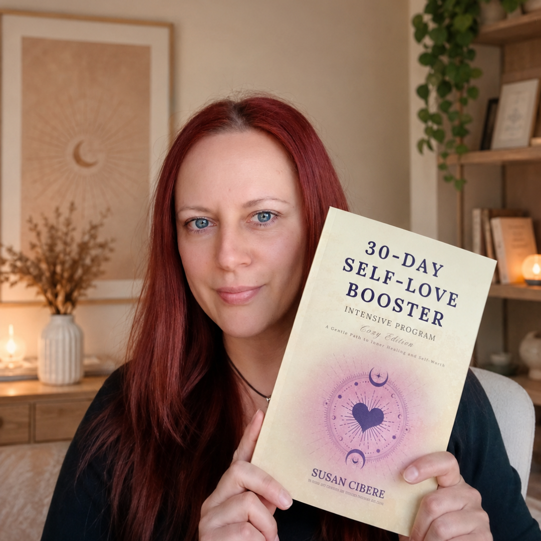 A woman with long red hair holds up a book titled '30-Day Self-Love Booster' by Susan Cibere in a warmly lit home office setting.